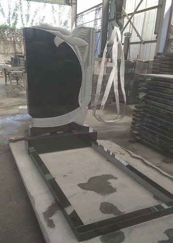 Black Granite Headstone With White Swans Carved